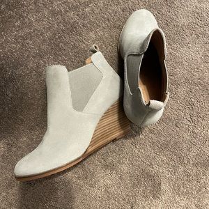 Woman’s light grey suede ankle boots